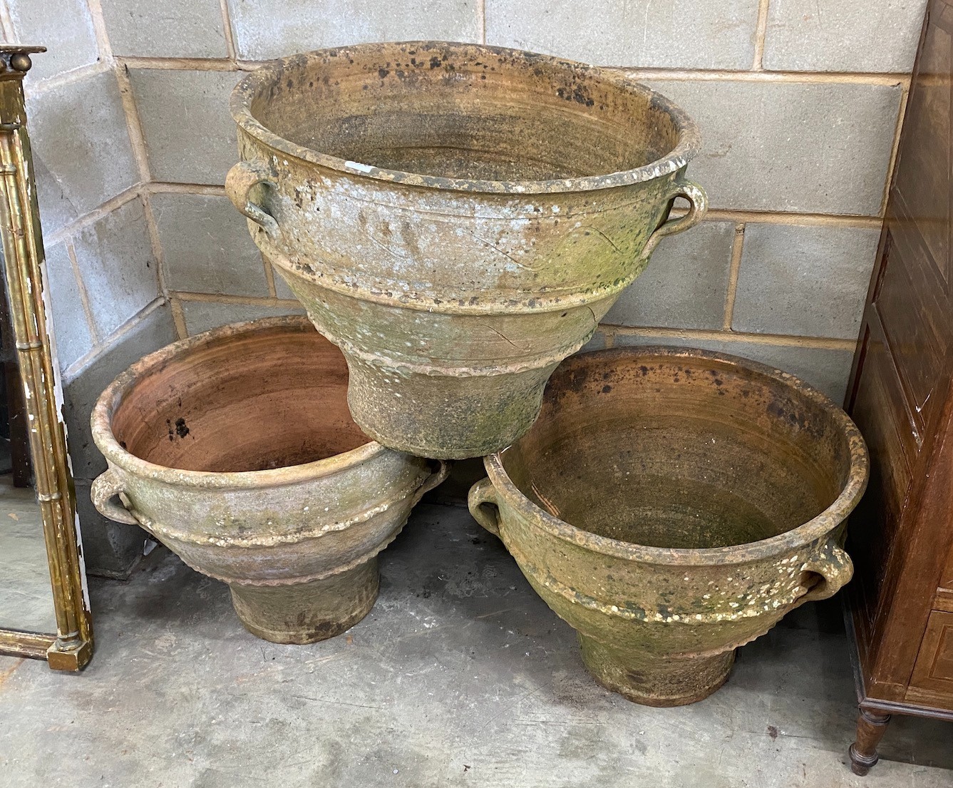 A set of three Greek style circular terracotta planters, diameter 62cm, height 50cm